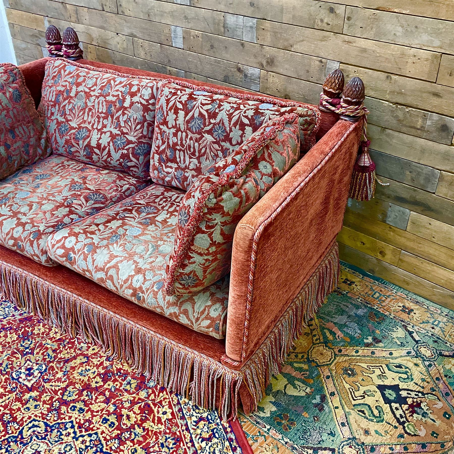 Knole type drop arm sofa with cushions in a traditional patterned upholstery,