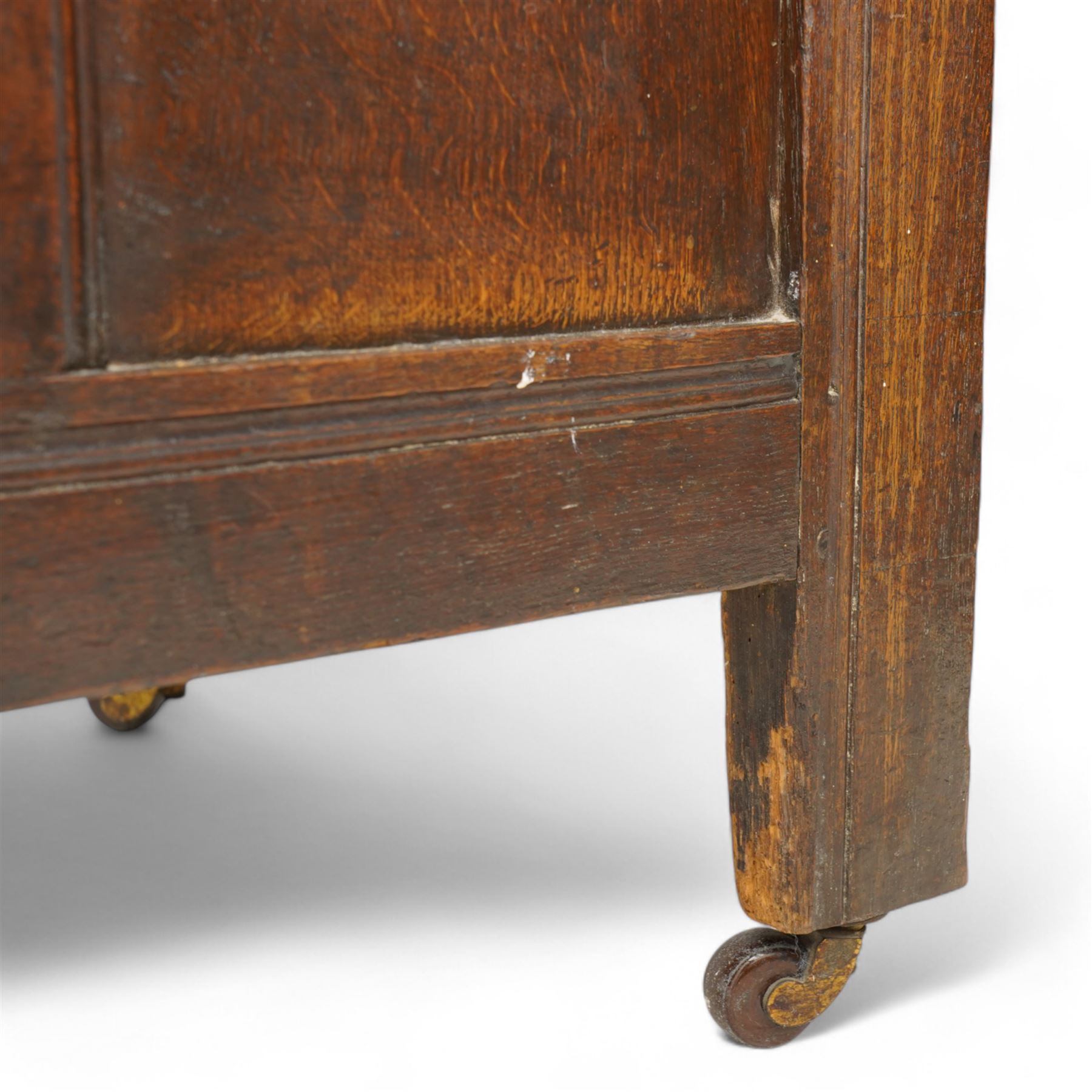 18th century oak blanket box, moulded rectangular hinged lid over lunette carved frieze rail and panelled front, moulded frame and panelled sides fitted with carrying handles, on stile supports