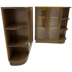 Pair of mid-20th century oak bookcases, rectangular form with curved ends, enclosed by glazed doors and fitted with shelves