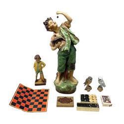 Early 20th Century continental plaster figure modelled as an eating cherry picker boy, H68cm, together with boxed dominos, owl figures, other games etc