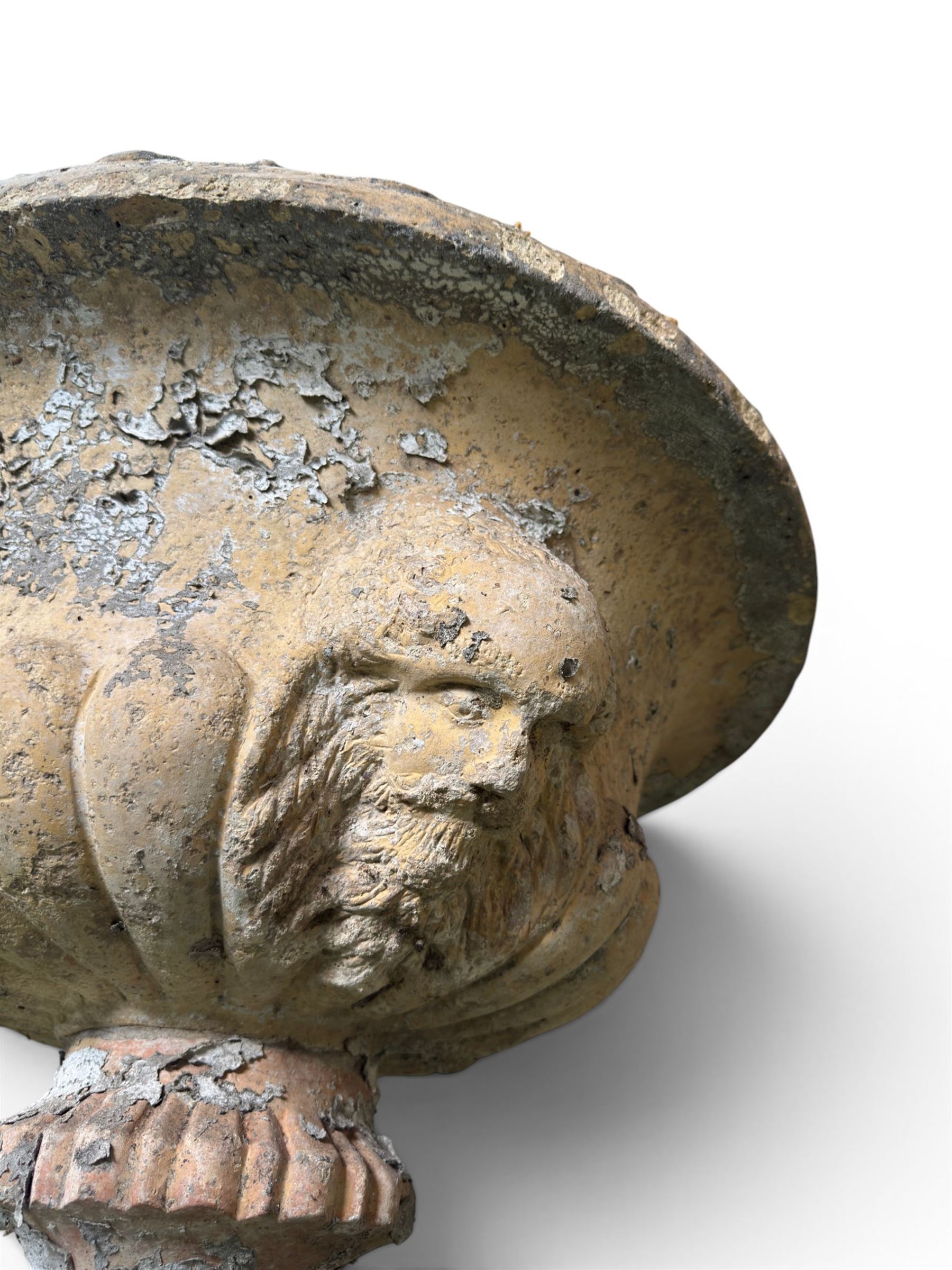 19th century terracotta campana shape urn planter, egg-and-dart moulded rim over a cherub-mask and gadrooned underbelly, turned pedestal and socle on square base