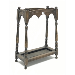 Early 20th century oak stick and umbrella stand, three divisions, turned supports, with metal drip tray, W52cm, H70cm, D25cm