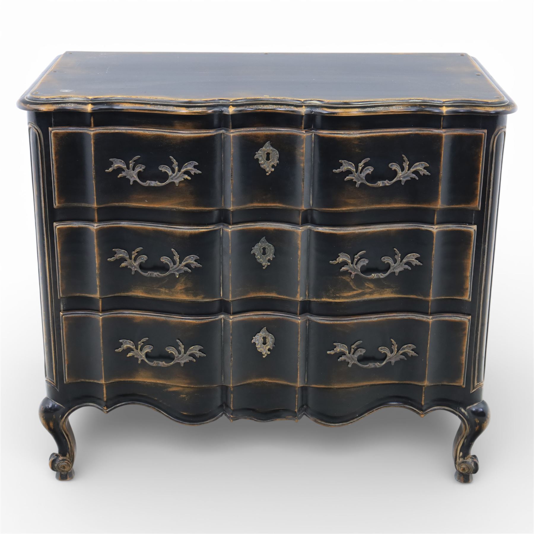 French style black lacquered chest of drawers, the serpentine front fitted with three graduated drawers mounted with scrolling foliate metal handles and key plates, shaped apron and scrolled cabriole legs