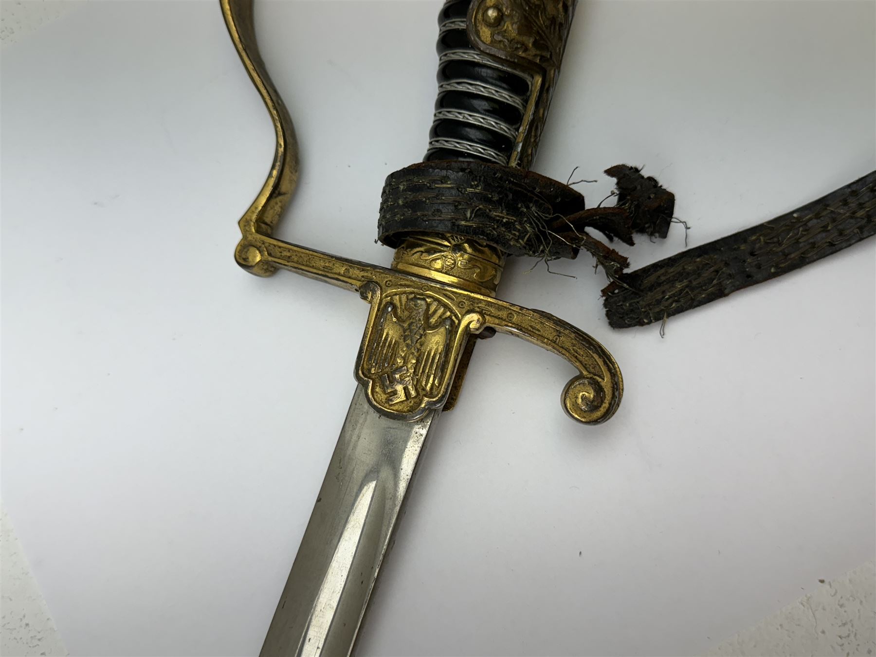 German infantry dress sword, dove head stirrup handle with black wire-bound grip cast cross guard with German eagle set into the langet, the curved 81cm single edge blade with single fuller marked Elckhorn Solingen, L93cm overall