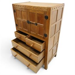 Mouseman - mid-20th century adzed and panelled oak tallboy chest, arcade carved cresting rail over two panelled cupboard doors with wrought iron fittings and latch, enclosing single shelf, over two short and two long drawers with lightly adzed facias and turned knob handles, raised on square supports, relief carved mouse signature, by the workshop of Robert Thompson of Kilburn