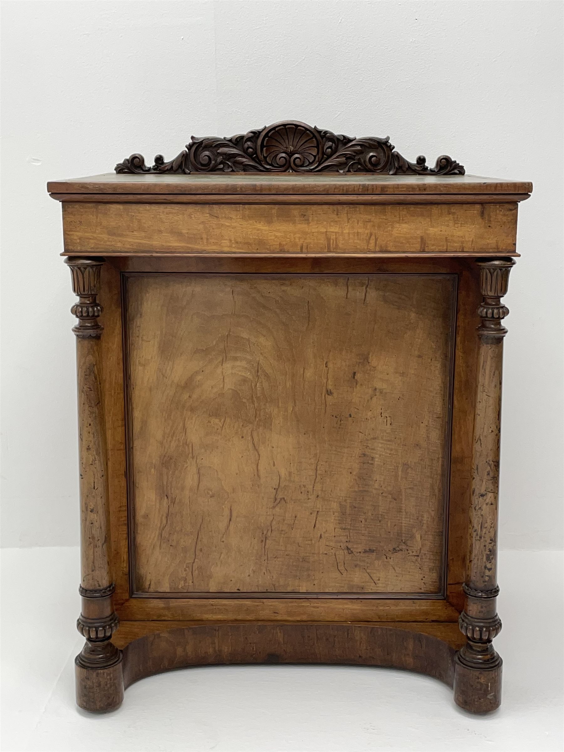 Early Victorian figured mahogany dressing cabinet, the raised shell and scroll carved back lifts to reveal rectangular easel mirror with mahogany band, flat rectangular top with tooled leather inset, slide at each side with matching leather inset, full width drawer above cupboard enclosing a series of five drawers, turned front supports, panelled front, sides and back