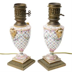 Pair of Sevres style table lamps, with pink and gilt floral decoration, apocryphal marks t...