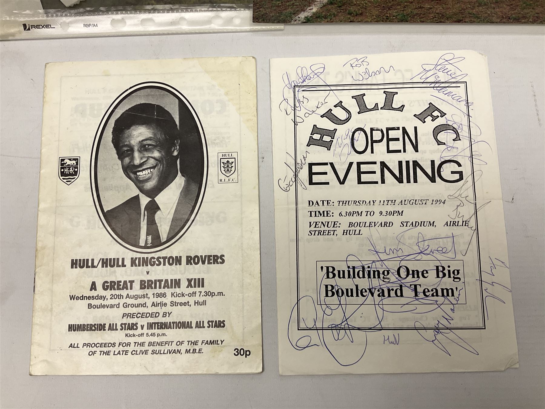 Hull F.C. memorabilia; Clive Sullivan 1986 memorial game programme, Open Evening 1994 programme with multiple player signatures, 'Old Faithful' 45rpm record, Wembley rosettes, 2000 team poster with facsimile signatures, framed print 'Farewell to the Boulevard 1895-2002', fully signed team photograph, various booklets, CD, DVD etc; and a folder containing the Merlin Rugby League card collection
