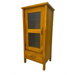 Laura Ashley - contemporary Milton oak display cabinet, featuring single door with two glass panels and pewter effect handle, enclosing one fixed oak shelf and two adjustable glass shelves, access hole at the bottom shelf, over single drawer with matching handle, on square legs