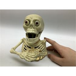 Cast iron mechanical money box in the form of a skeleton, H16cm