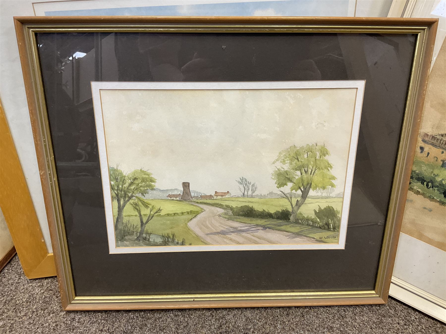 G A Townsend (British 20th century) 'The Trout Inn', watercolor signed and dated; M C W (British 20th century) The Wolds watercolor signed and dates, together with another watercolour and three landscape prints