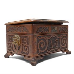 Arts & Crafts Design oak sewing box carved with initials and dated 1907, with sliding top, lion mask ring handles on shaped supports. W36cm