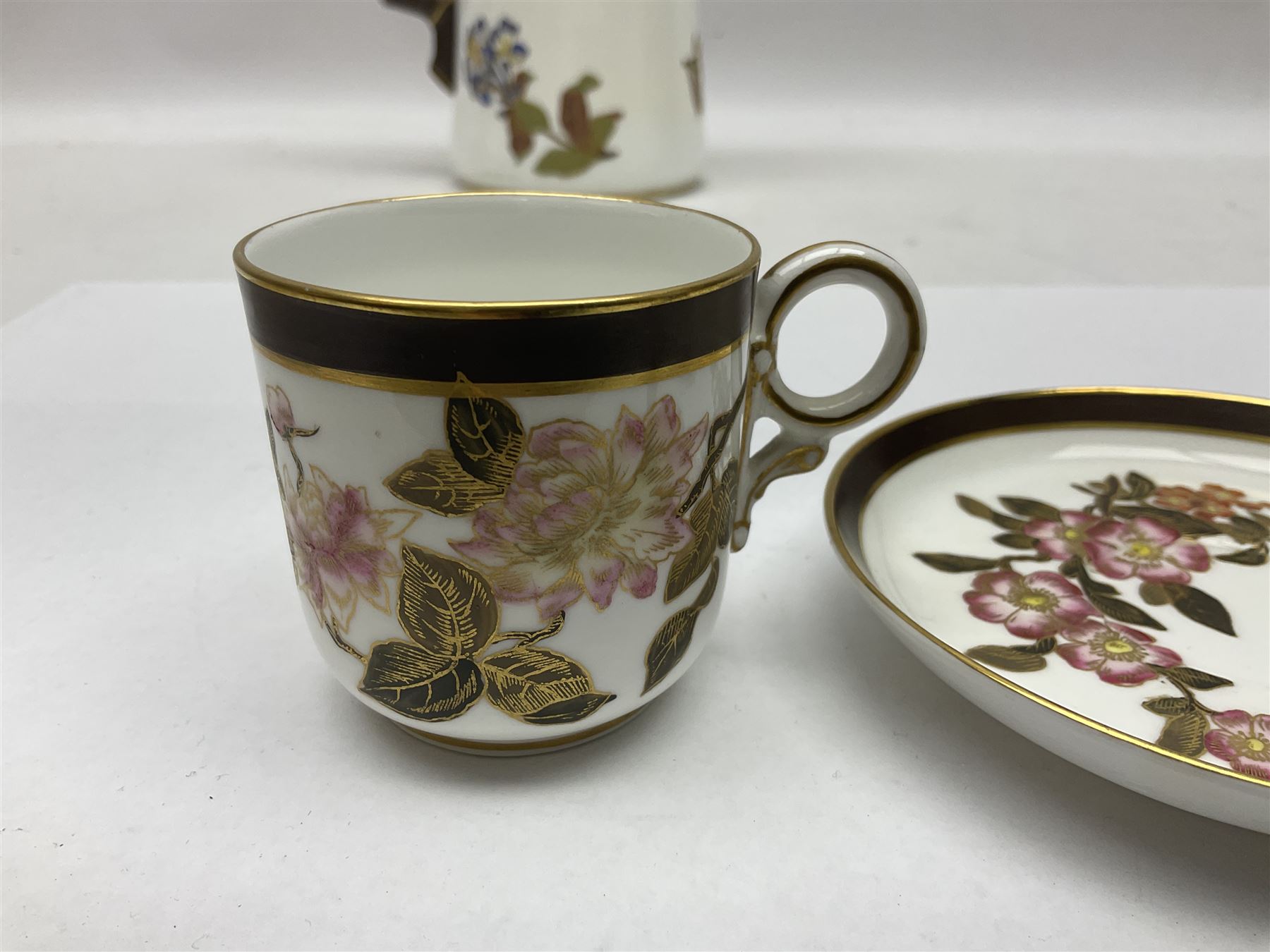 Royal Worcester coffee pot, coffee cup and saucer, all decorated with floral sprigs and butterflies, the coffee pot with a bamboo handle, H23cm