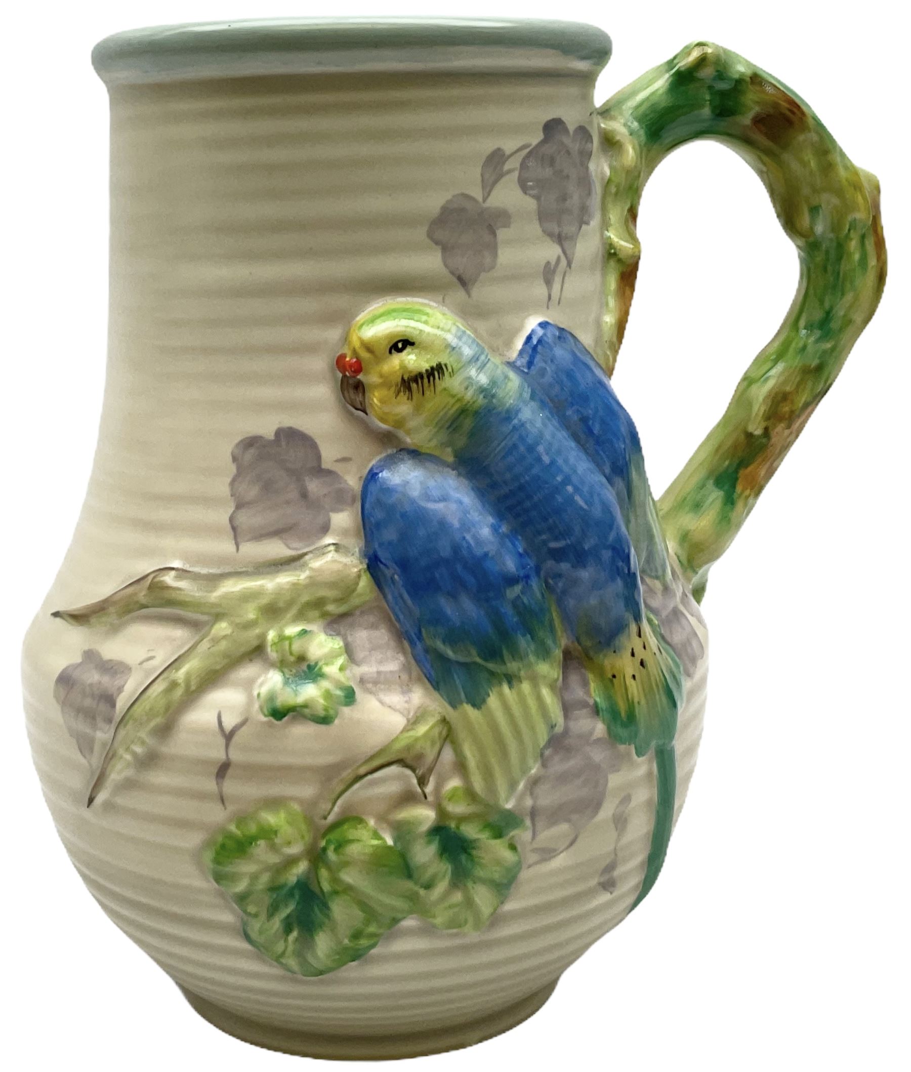 Clarice Cliff baluster jug moulded with a blue budgerigar perched upon branch with green rustic handle and mushroom glaze,  factory stamped beneath, H22.5cm