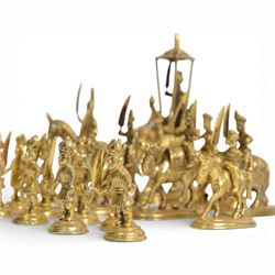 19th century Moghul Indian silver and silver gilt chess set, comprising thirty-two pieces, modelled as soldiers mounted upon elephants, camels and horses with the pawns on foot, unmarked, King H10cm