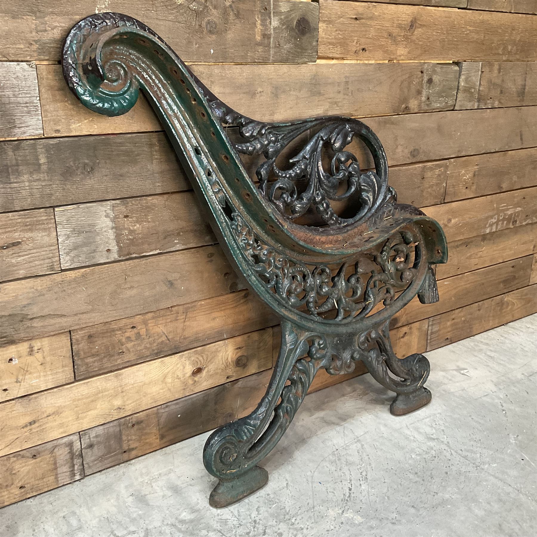 Early 20th century heavy cast iron three piece bench ends, decorated with scrolls and floral swags
