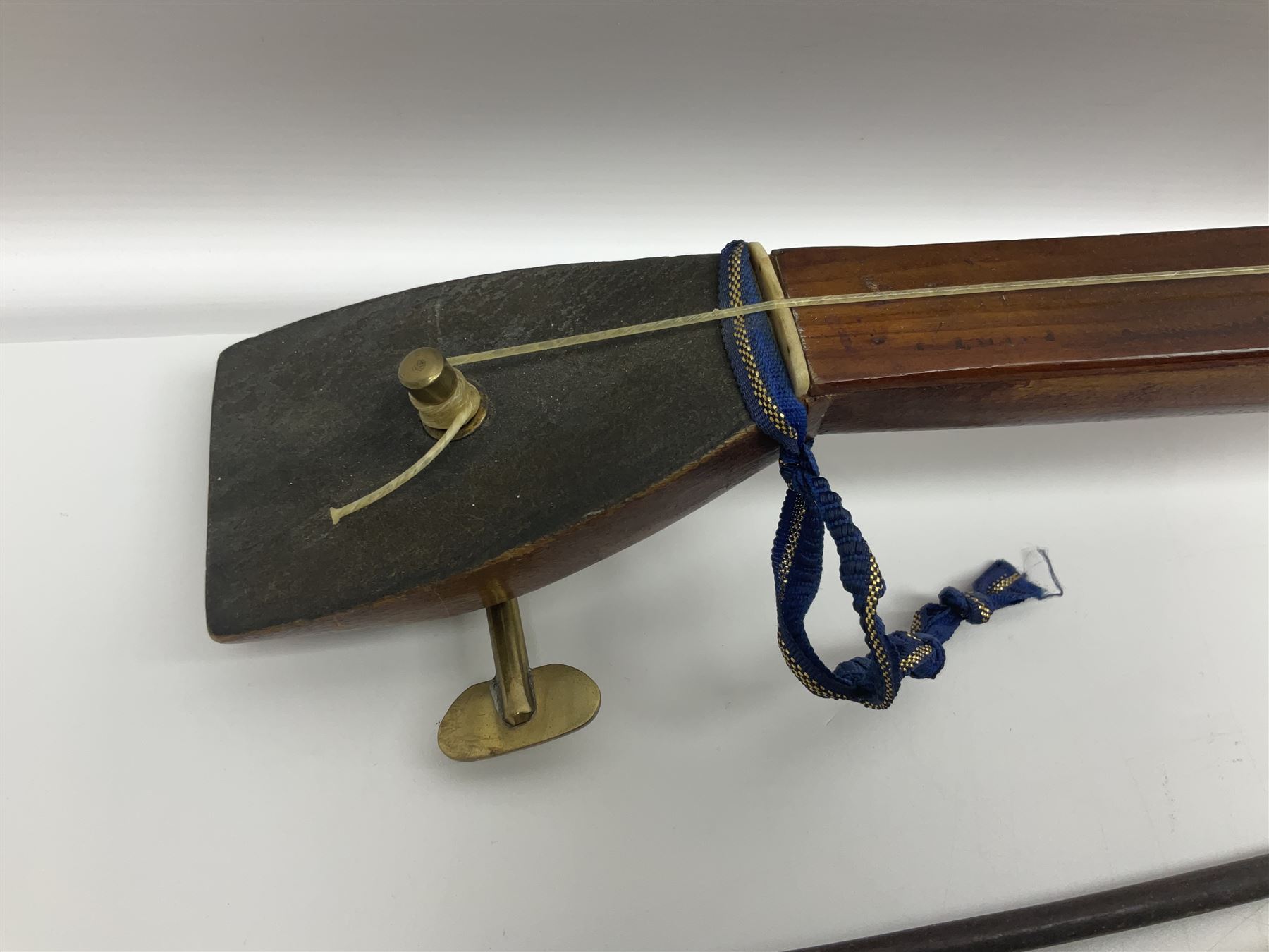 Fruitwood and elm single string phono fiddle with long neck and copper horn L76cm; and a violin bow (2)