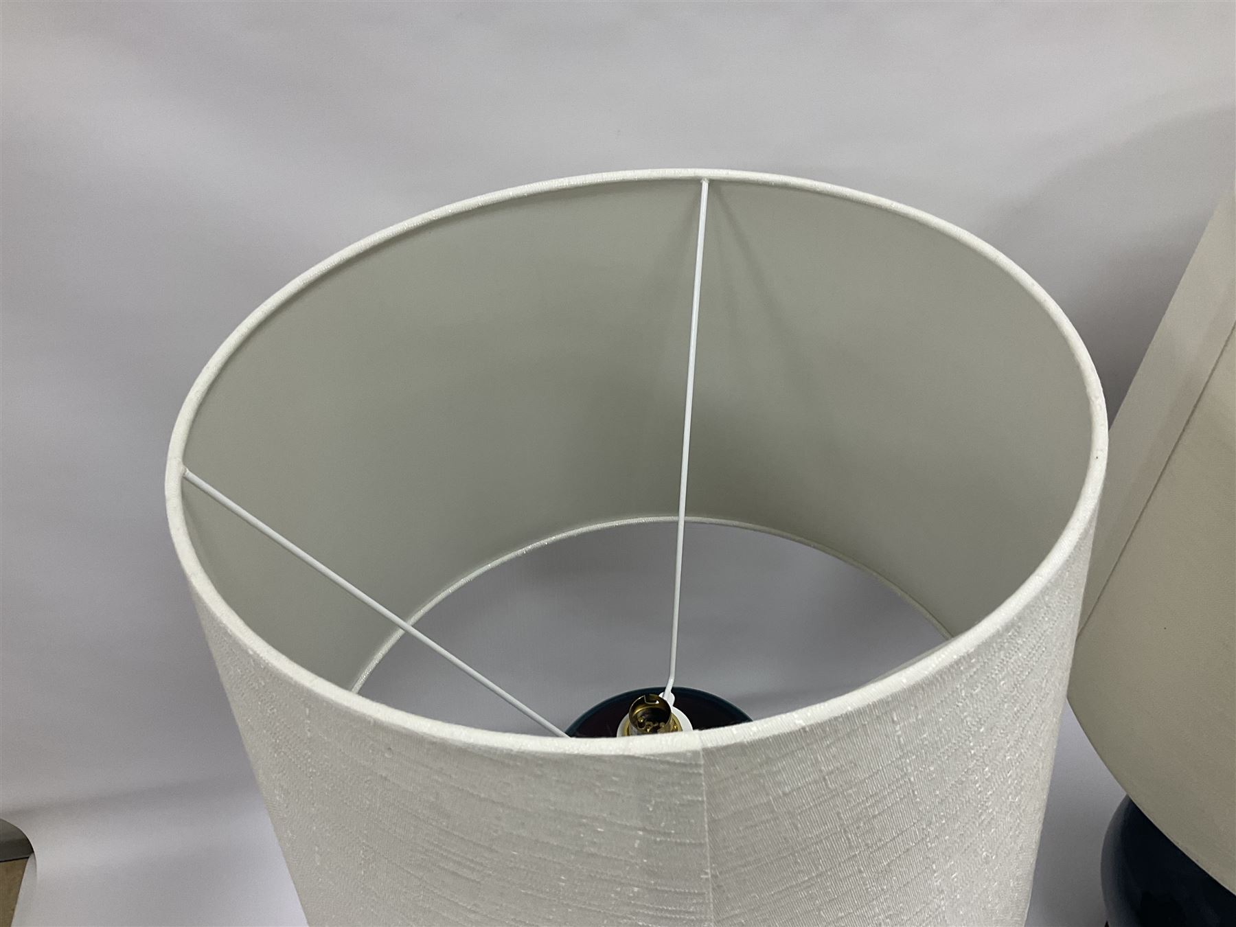 Pair of Chinese teal glazed table lamps, each of bottle form, raised upon circular hardwood bases, including shade H72cm 