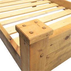 Alexander Ellis of Beverley - rustic pine king sized bed, of plank form construction with visible dowels, raised on stile supports