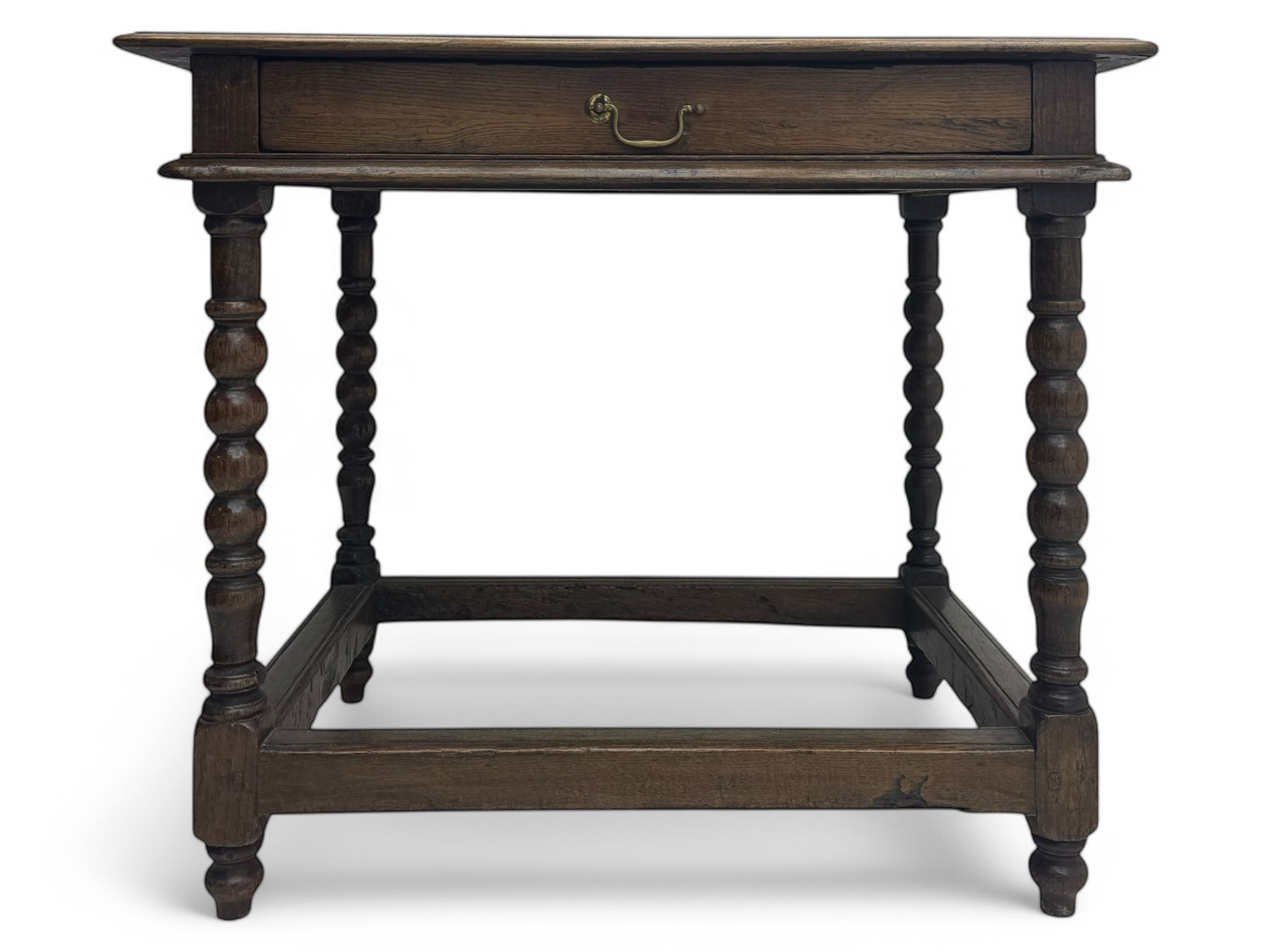 Late Victorian oak side table, rectangular top with moulded edge and frieze drawer with brass handle, raised on turned bulbous supports united by square-section stretchers
