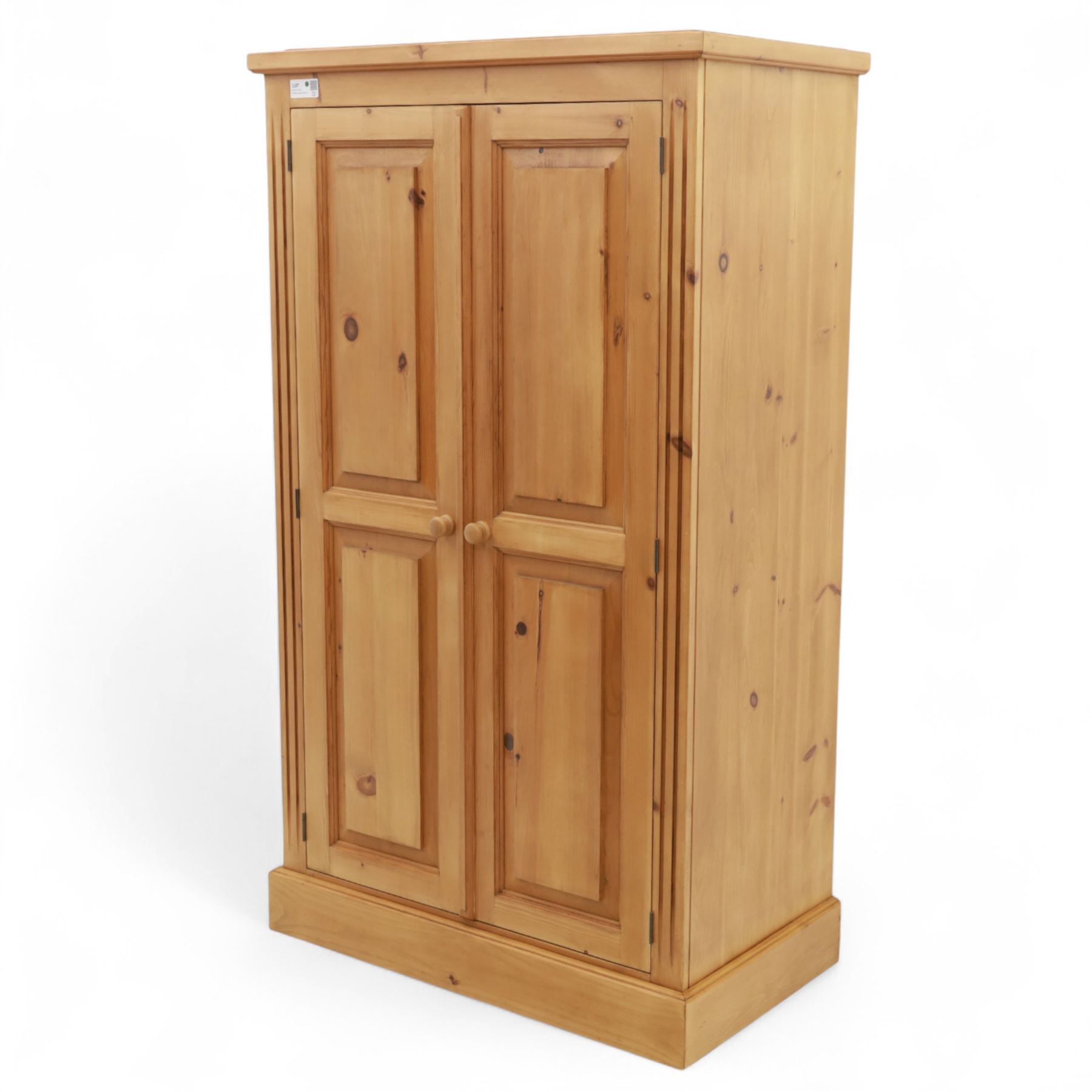 Modern stripped pine two-door wardrobe, the fielded panel doors with turned knob handles, opening to a double rail hanging interior, beneath a stepped cornice and raised on plinth base