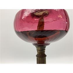 Victorian table standing oil lamp, brass fittings, cranberry glass reservoir, brass column on black enamelled ceramic base, with a frosted glass shade and clear glass chimney, H68cm