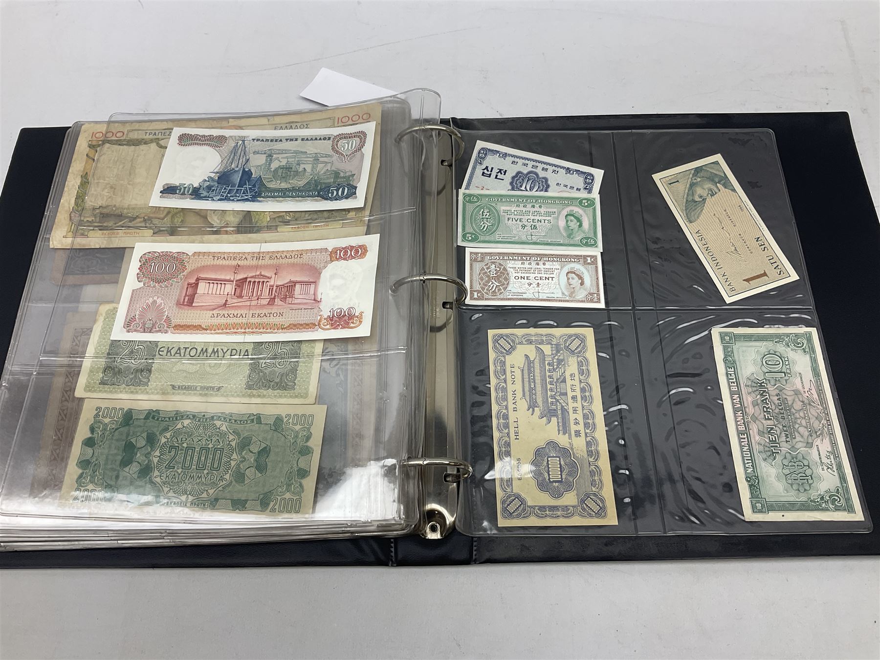World banknotes, including Queen Elizabeth II The States of Jersey one pound 'DB202703', five pounds 'BB527762' and ten pounds 'AB651481', reserve bank of New Zealand two dollars '1L3 741894', King George V Straits Settlements one dollar 1st January 1935 'F/83 28924', various Bank of England notes etc, housed in two ring binder albums