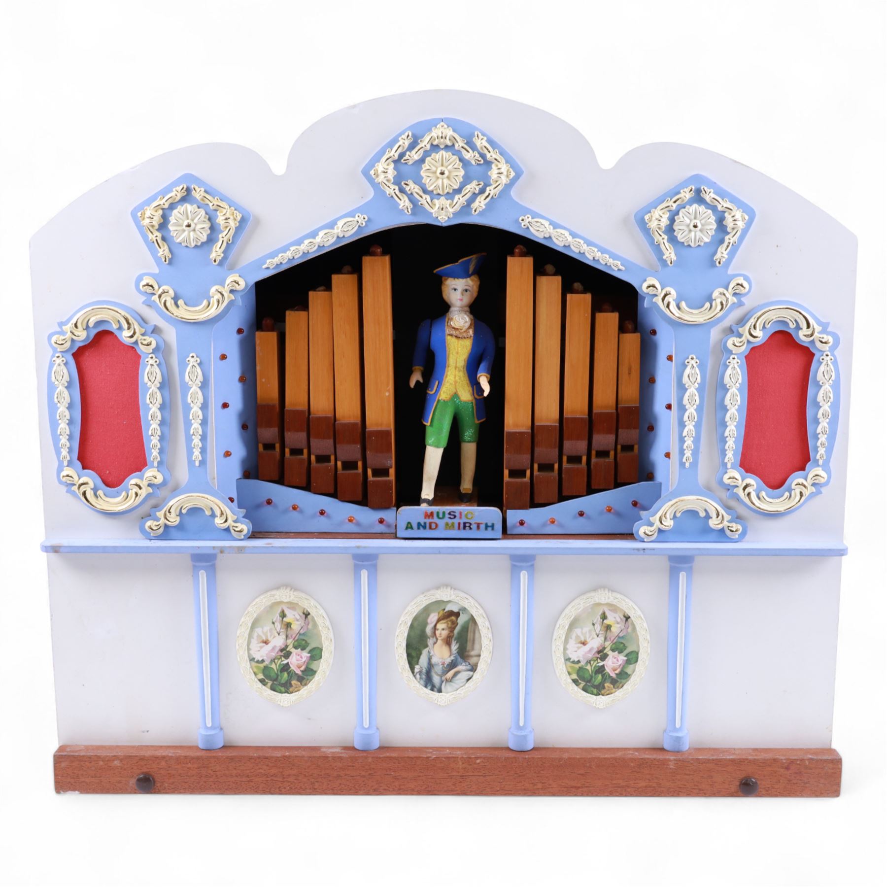 John Smith-20th century hand cranked portable street organ “music and mirth” in a wooden case with carrying handles, with speaking pipes and mannequin to the front. All pipes present, however the mechanism is in need of restoration. With five paper music rolls.