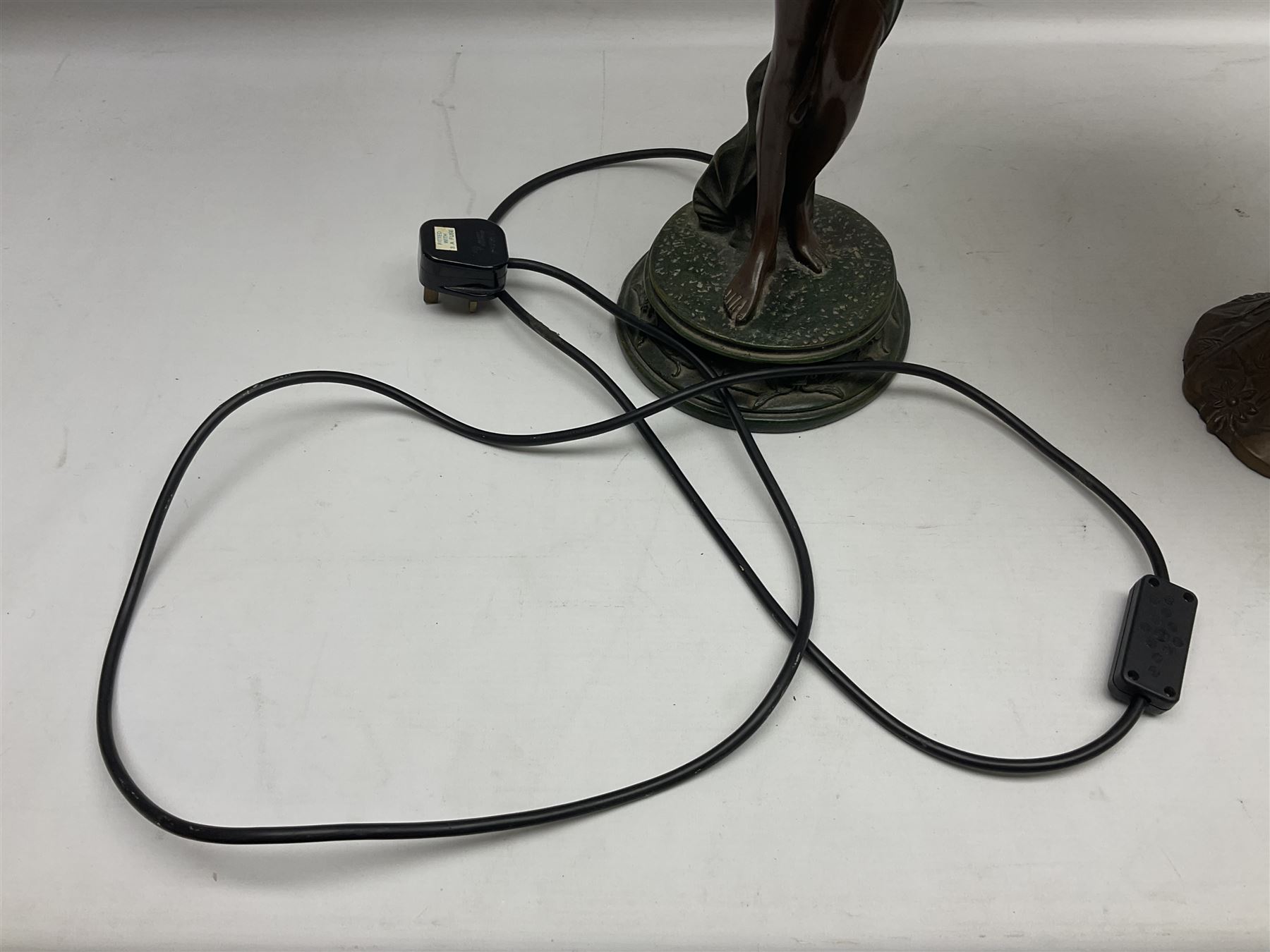 Tiffany style lamp in the form of a semi nude woman holding up a leaded lampshade together with a similar table lamp