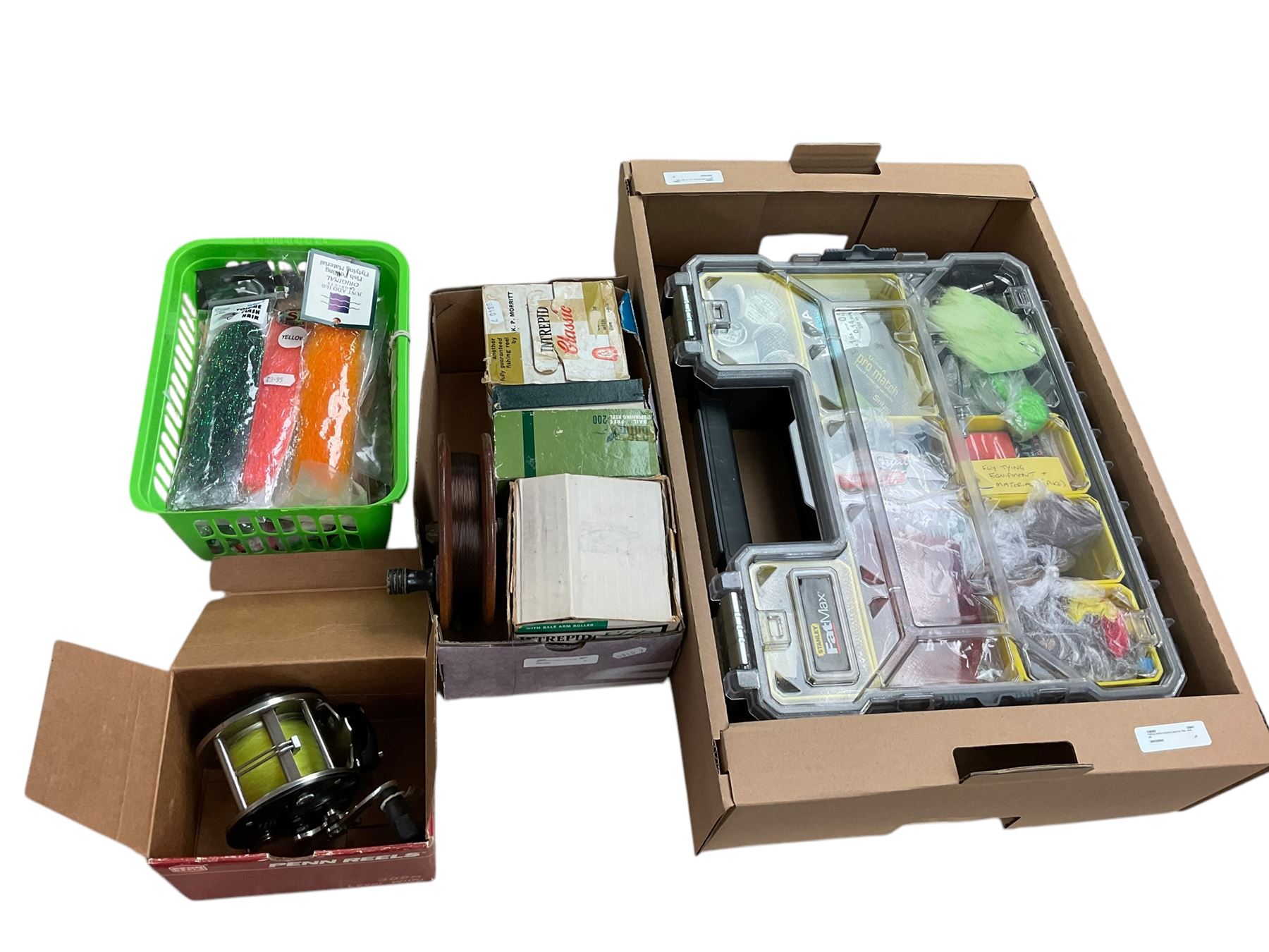Two boxes of assorted fly fishing flies together with can fishing rod and other fishing tackle