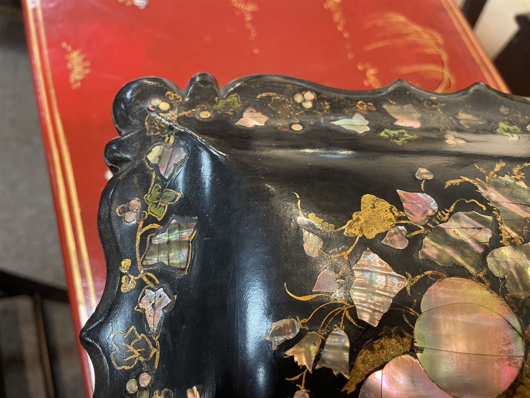 Victorian black lacquered papier-mâché sewing box, of rectangular form with shaped sides, the slightly domed top with inlaid mother of pearl and abalone decoration, the sides with gilt and polychrome painted scrollwork, the hinged cover opening to reveal a fitted interior with lift out tray, H14cm