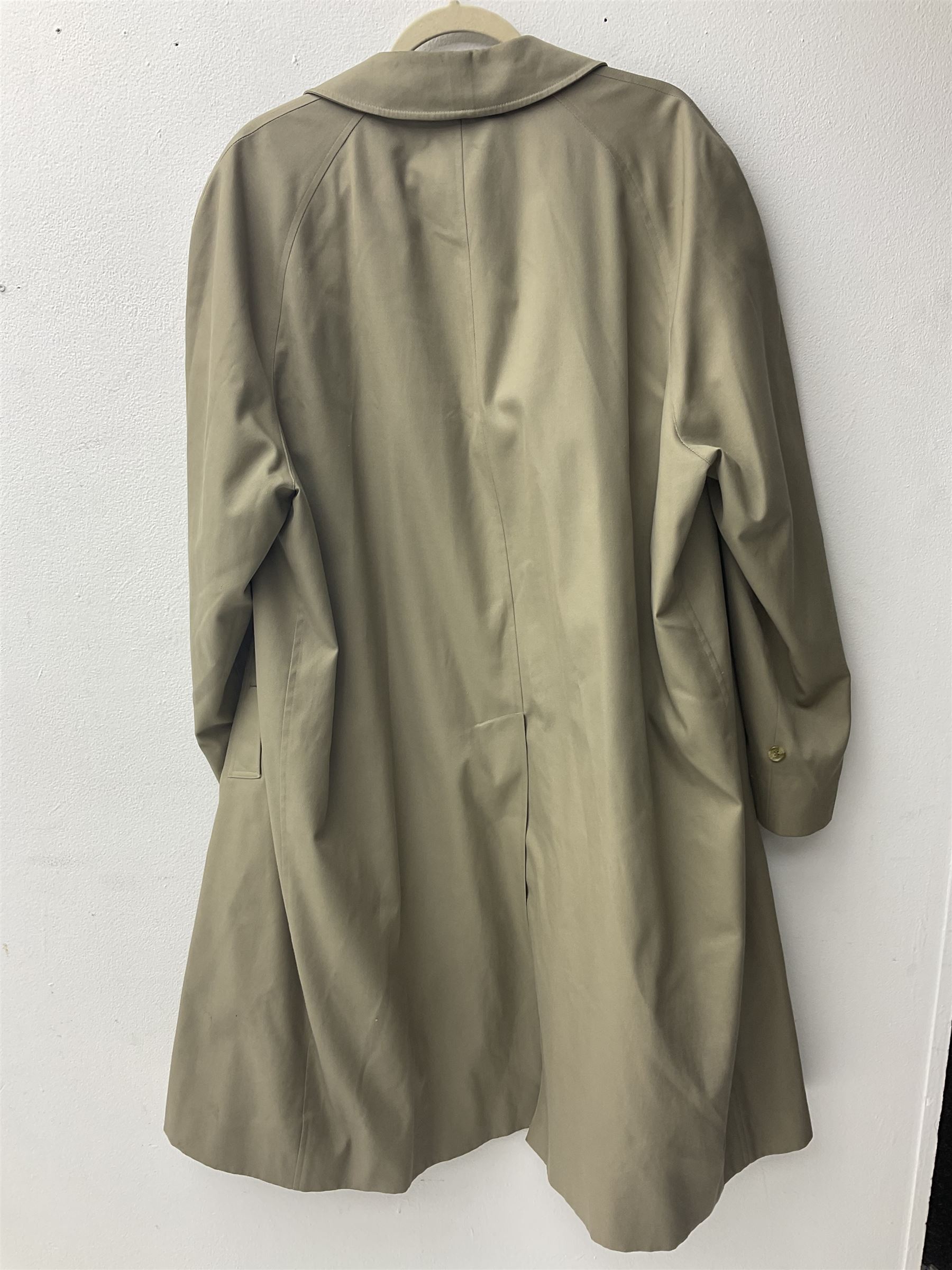 Ladies Burberry double breasted trench coat, with belt and detachable woollen gilet, in traditional cream colour with Burberry check lining, together with a gentlemans Burberry single breasted trench coat, both L112cm
