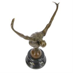 Bronze figure, modelled as a diver with hands raised upon a stepped circular base, H28cm