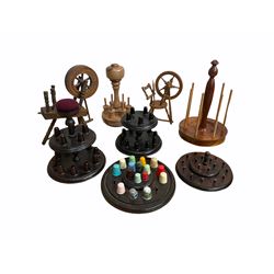 A group of 20th century turned wood thimble and bobbin stands, together with two miniature turned spinning wheels (8)