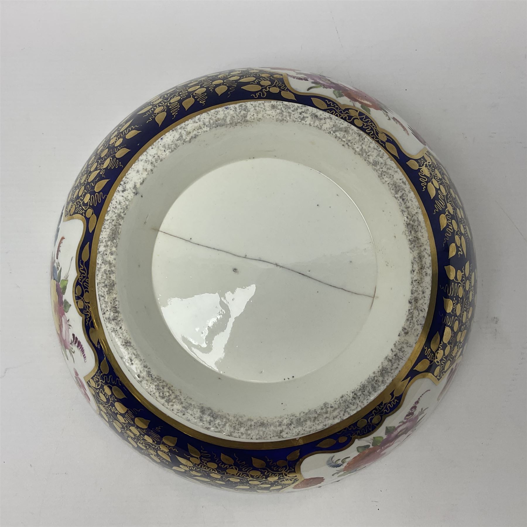 19th century continental bowl, decorated with hand painted floral sprays amongst gilt foliate decoration on a cobalt blue ground, D27.5cm