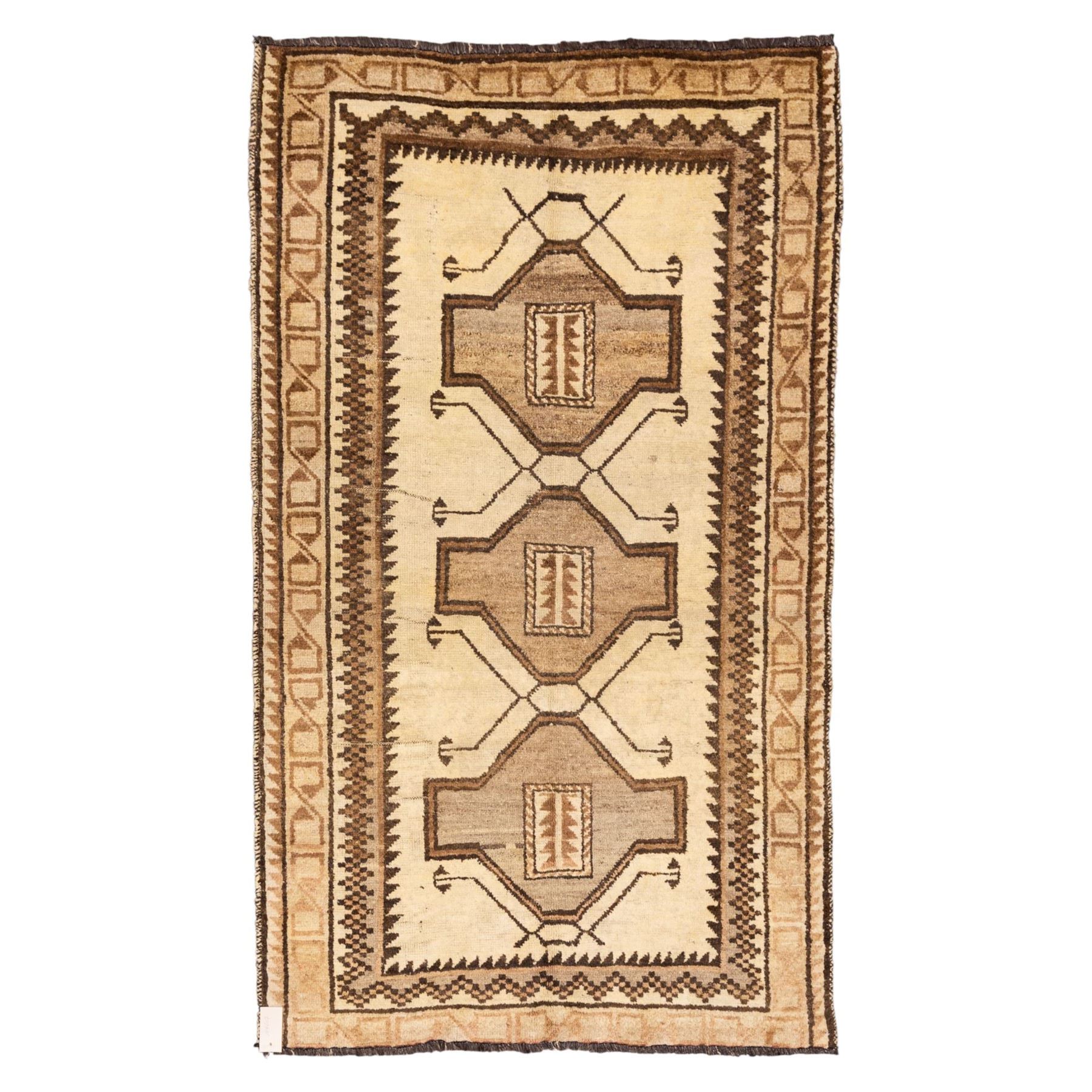 North West Persian Gabeh hand-knotted rug, natural ivory field with a vertical sequence of three large stepped geometric medallions in soft shades of brown and taupe, each enclosing stylized tribal motifs, flanked by narrow guard borders incorporating chevron and zigzag designs, with fringe ends 