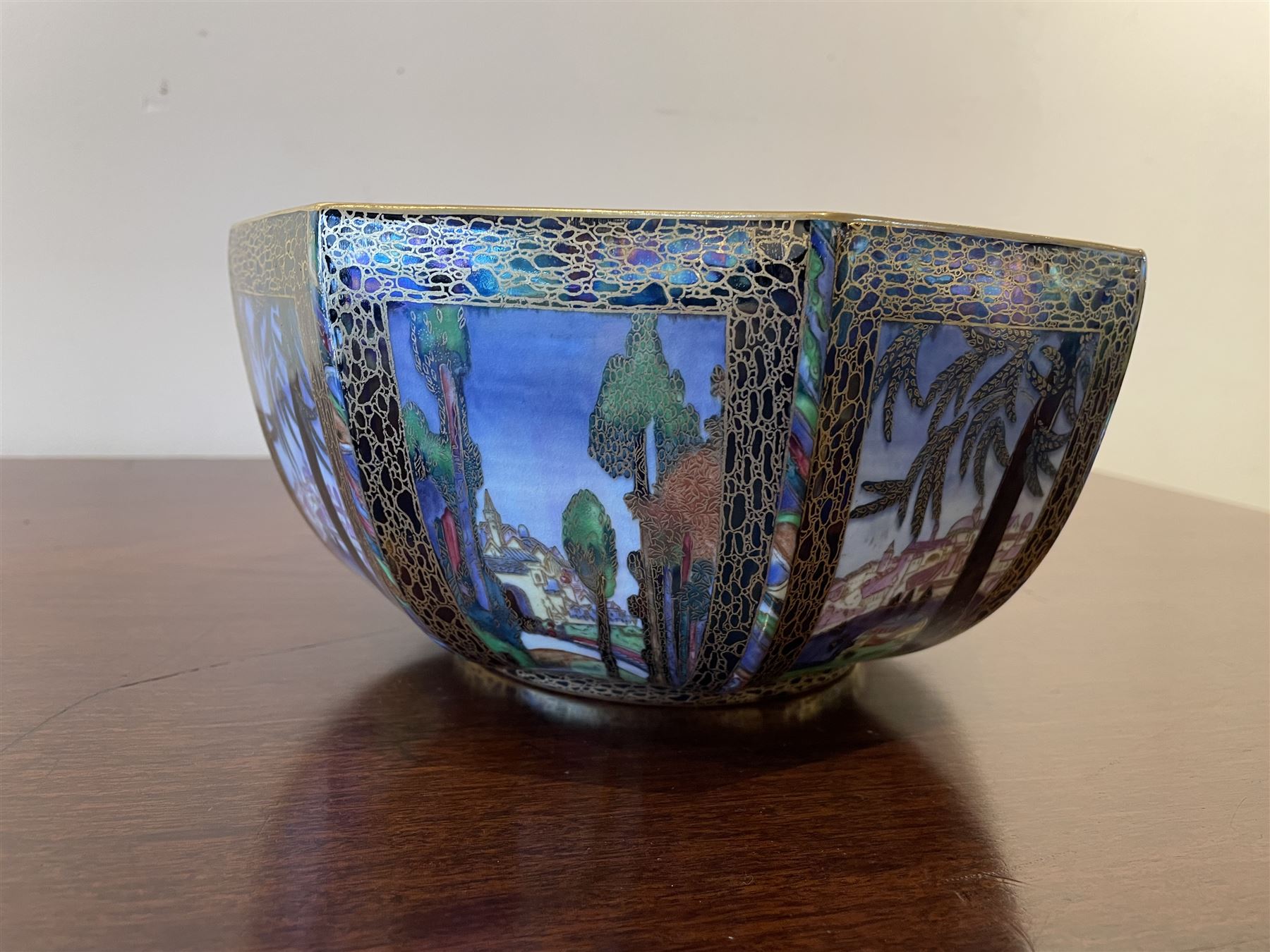 Early 20th century Wedgwood Fairland lustre bowl, circa 1920, of octagonal form, designed by Daisy Makeig-Jones, the exterior decorated in the Castle on the Road pattern, the interior decorated in the Fairy in a Cage pattern, pattern no Z5125, with printed marks beneath, H11cm D22.5cm
