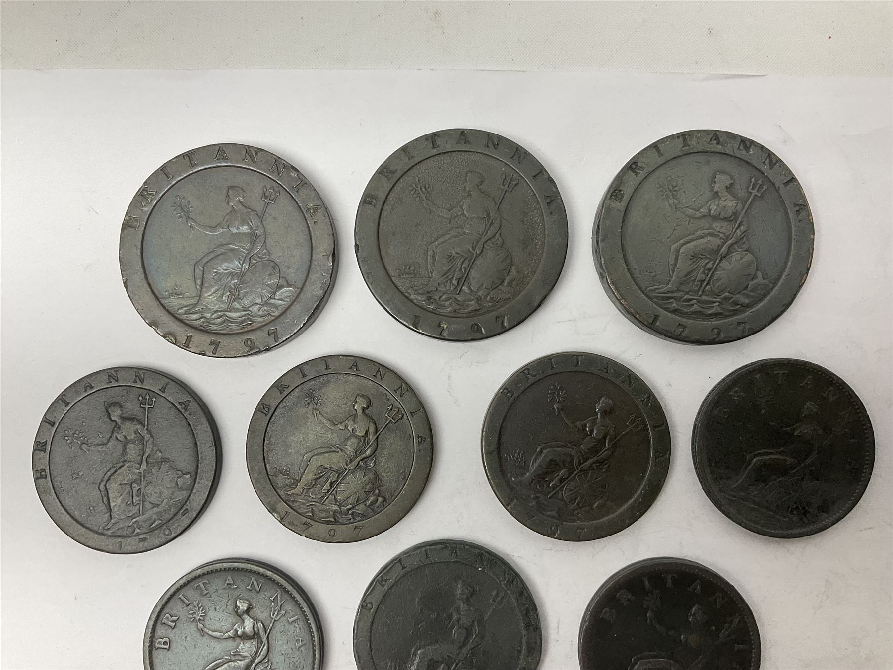 Two George III halfpenny coins dated 1799 and 1806, four pennies dated three 1806 and 1807, four 1797 cartwheel pennies and three 1797 cartwheel two pence coins