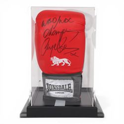 Lonsdale boxing glove, signed by Nigel Benn in black marker pen, in acrylic display box