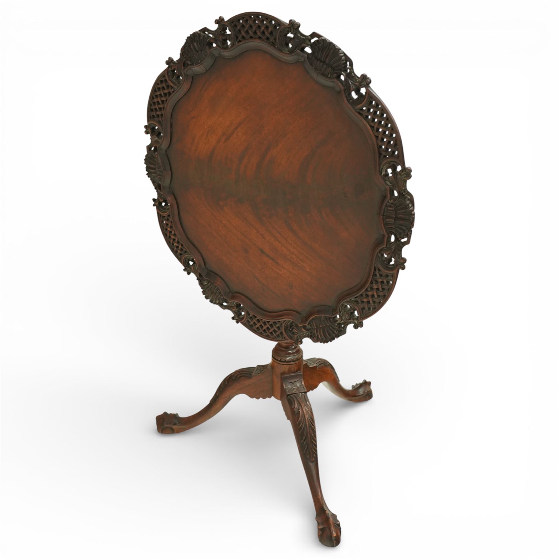 Late 19th century Rococo Revival mahogany occasional table, with shaped circular top with ornate lattice-pierced edge, decorated with pierced scallop motifs and acanthi, raised on a birdcage movement over turned pedestal, terminating to foliate-moulded tripod base with ball and claw feet