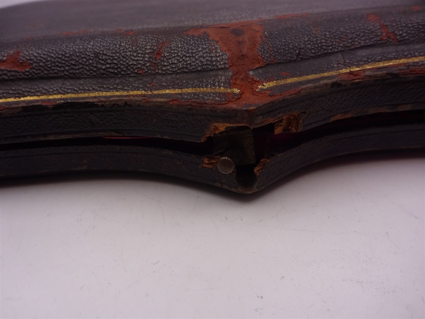 Set of ten Victorian silver coffee spoons, each with shaped scroll design rim, and a matching pair of sugar tongs, hallmarked Lee & Wigfull, Sheffield 1897, in tooled leather burgundy velvet and silk lined fitted case 