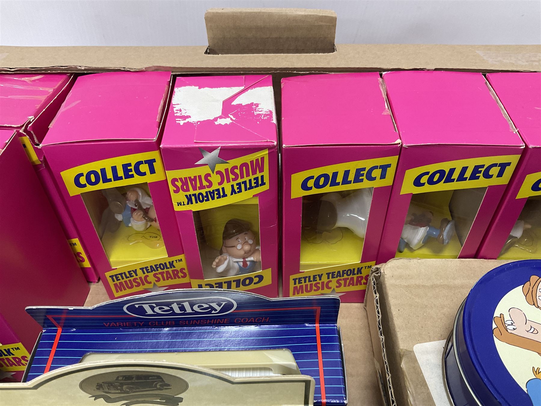 Collection of Tetley Tea collectibles to include sixteen 1:43 scale model cars from Lledo and Oxford Die-Cast with further Tetley Tea figures and tinned coaster set