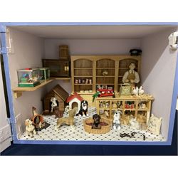 Three scratch-built wooden shop dioramas - single room Pet Shop with hinged front, fully furnished and well stocked with animals, birds and numerous accessories; and matching Garden Shop, fully furnished and well stocked with fruit, vegetables and garden accessories including lawn mower, wheelbarrows etc; each W34cm H27cm D26cm; and double fronted single room Butchers Shop with butcher at his block, partially stocked counter and two delivery cycles W57cm (3)