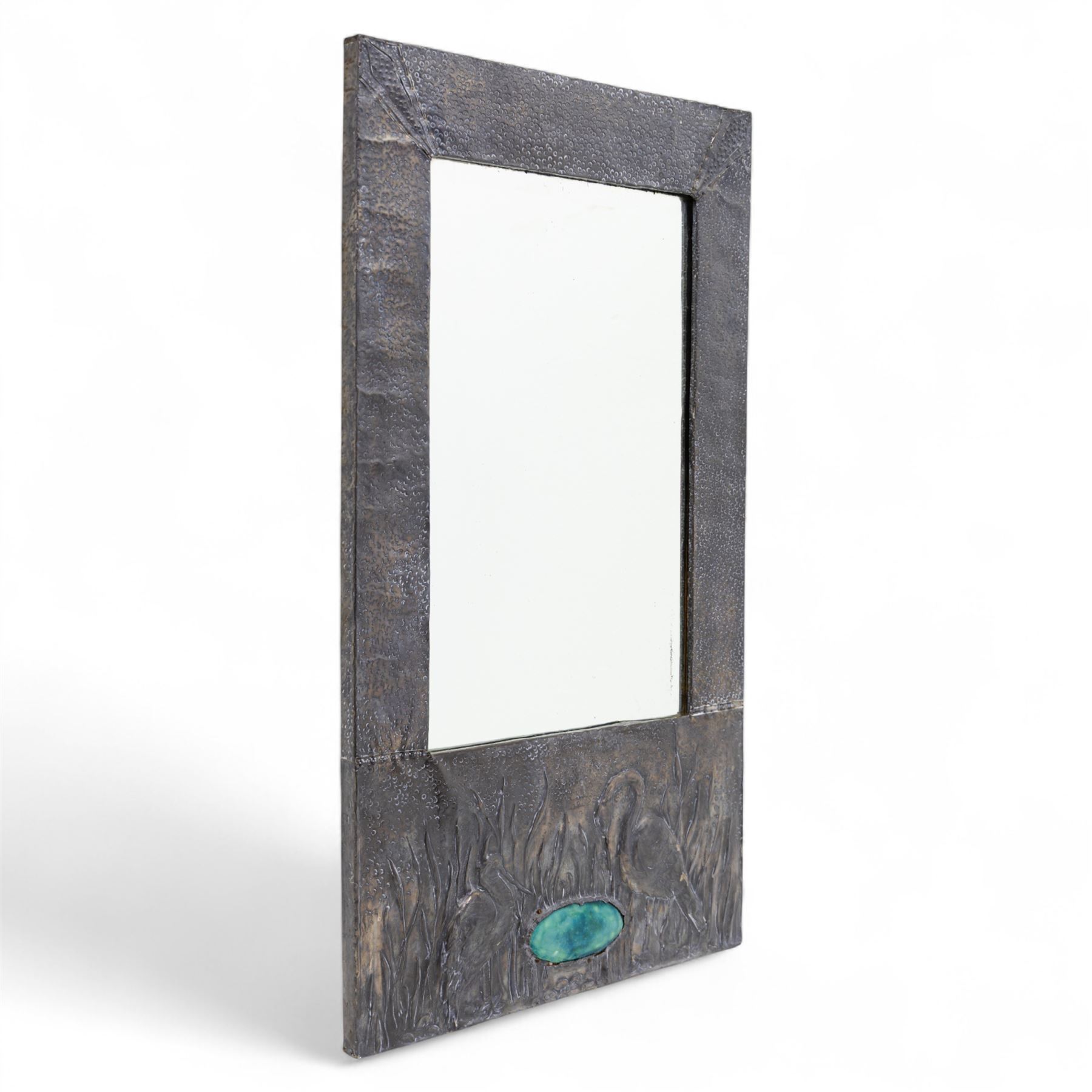 Early 20th-century Arts and Crafts pewter wall mirror, rectangular bevelled mirror plate within a punched pewter frame repoussé decorated with herons among reeds, with a central inset green enamel cabochon panel