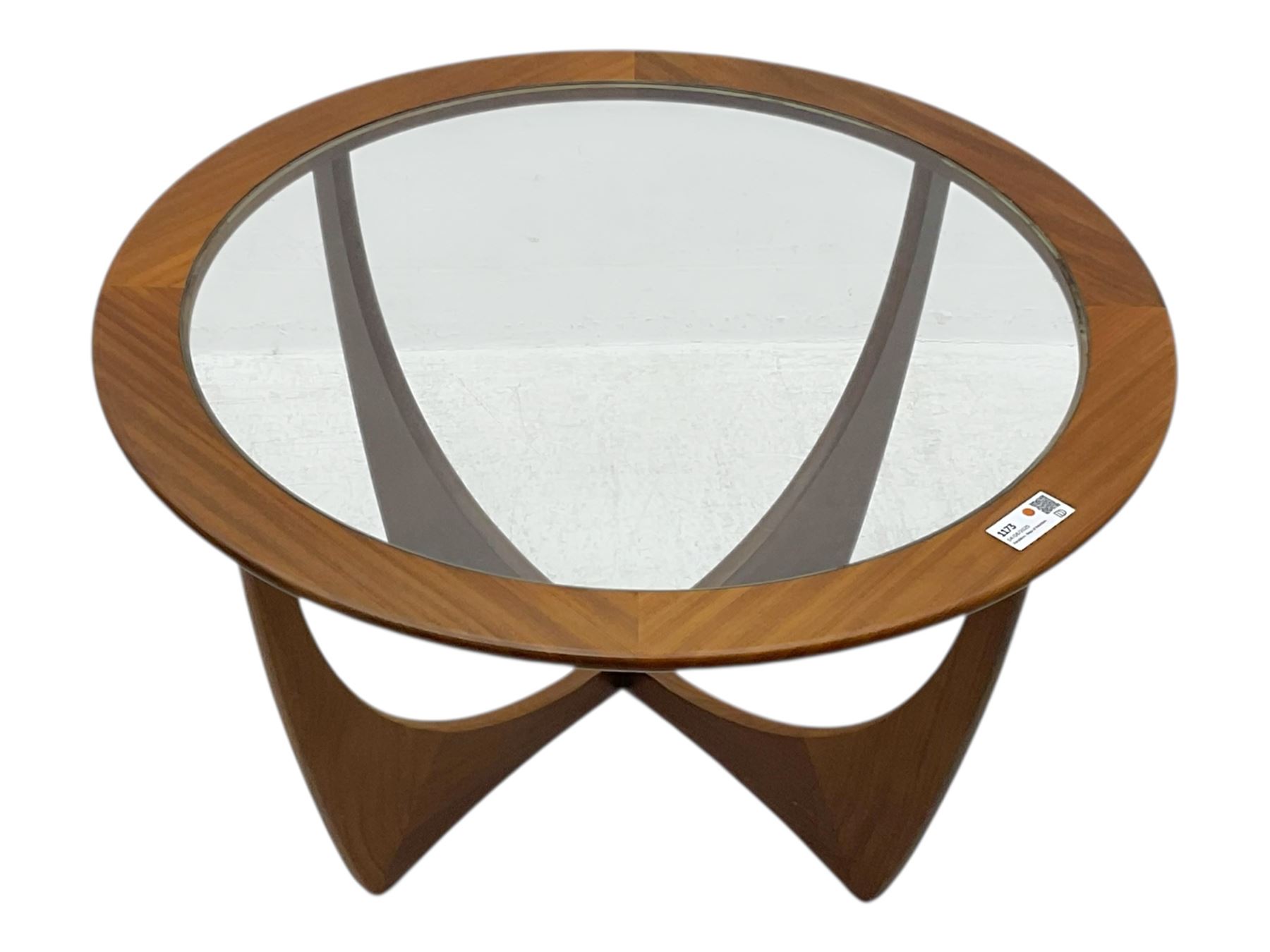 G Plan - Mid-century teak coffee table, circular form with inset glass top within a wide chamfered teak border, on sculptural cruciform base with curved intersecting supports