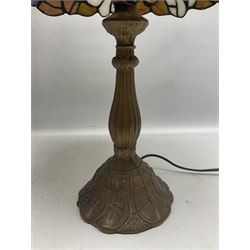 Tiffany style lamp in the form of a semi nude woman holding up a leaded lampshade together with a similar table lamp