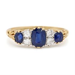 Early 20th century gold sapphire and diamond ring, three vari-cut sapphires, spaced by fou...