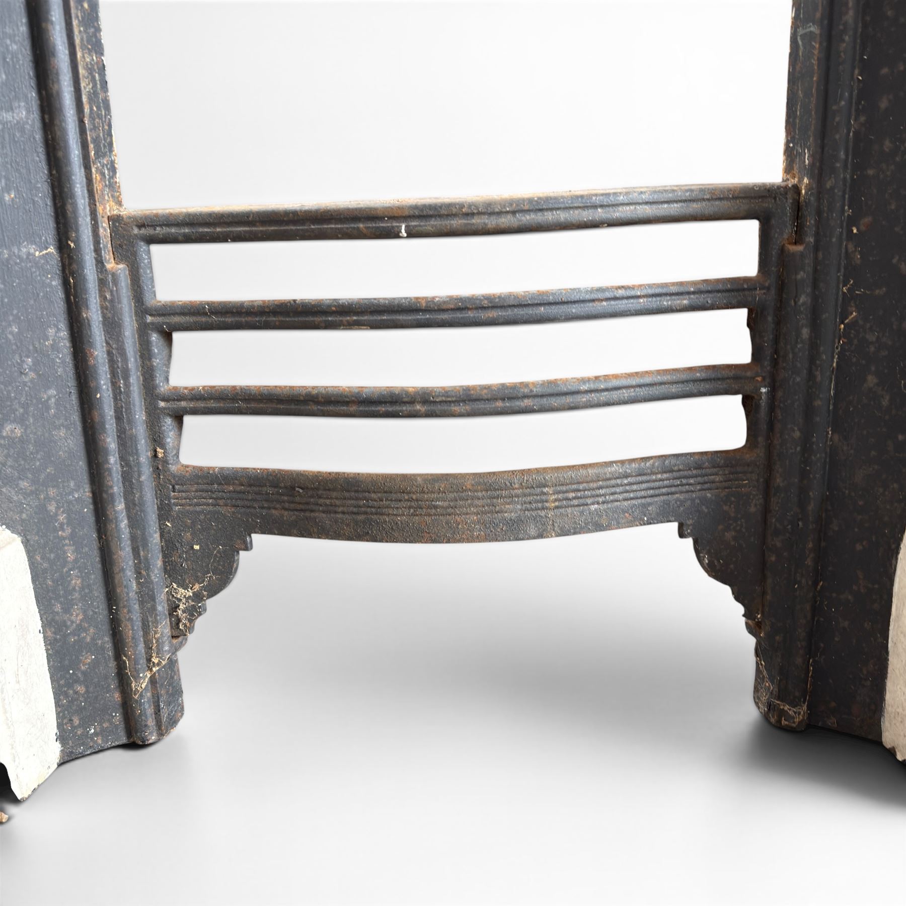 19th century Neoclassical design cast iron bedroom fire surround with fluted and rosette design, white painted finish with  black slip