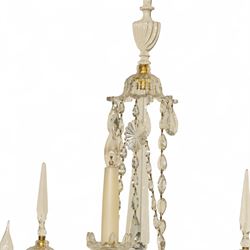 Pair of George III ormolu and cut-glass wall-lights, each with a tall central urn-shaped finial above a series of faceted glass spires and scrolled branches, the ormolu-mounted nozzles and drip pans hung with festoons of cut-glass drops and pear-shaped pendants, the lower section centred by a pineapple finial, wired for electricity