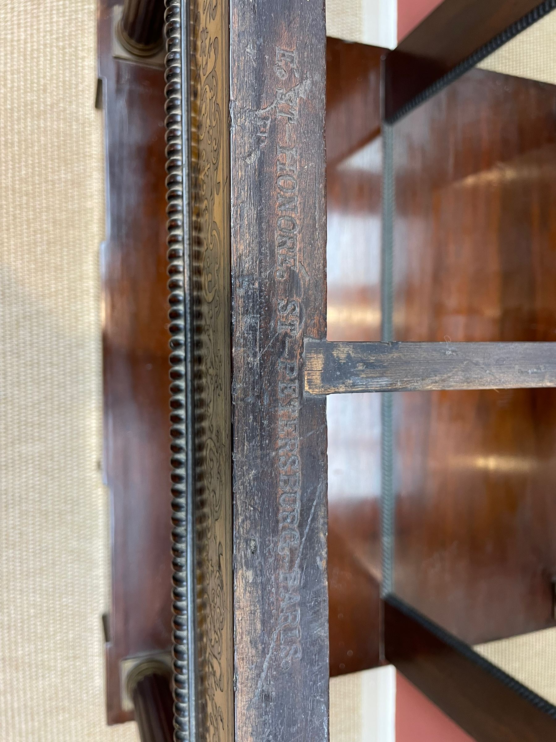 Late 19th century mahogany console or pier table, rectangular green marble top over a break-front frieze inlaid with brass scroll work panels, reed and ribbon gilt metal and wooden beaded applied mouldings, on turned and fluted front supports, plain mirror back over plinth platform base